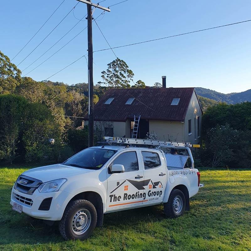 the roofing group local skylight installers work vehicle parked outside house